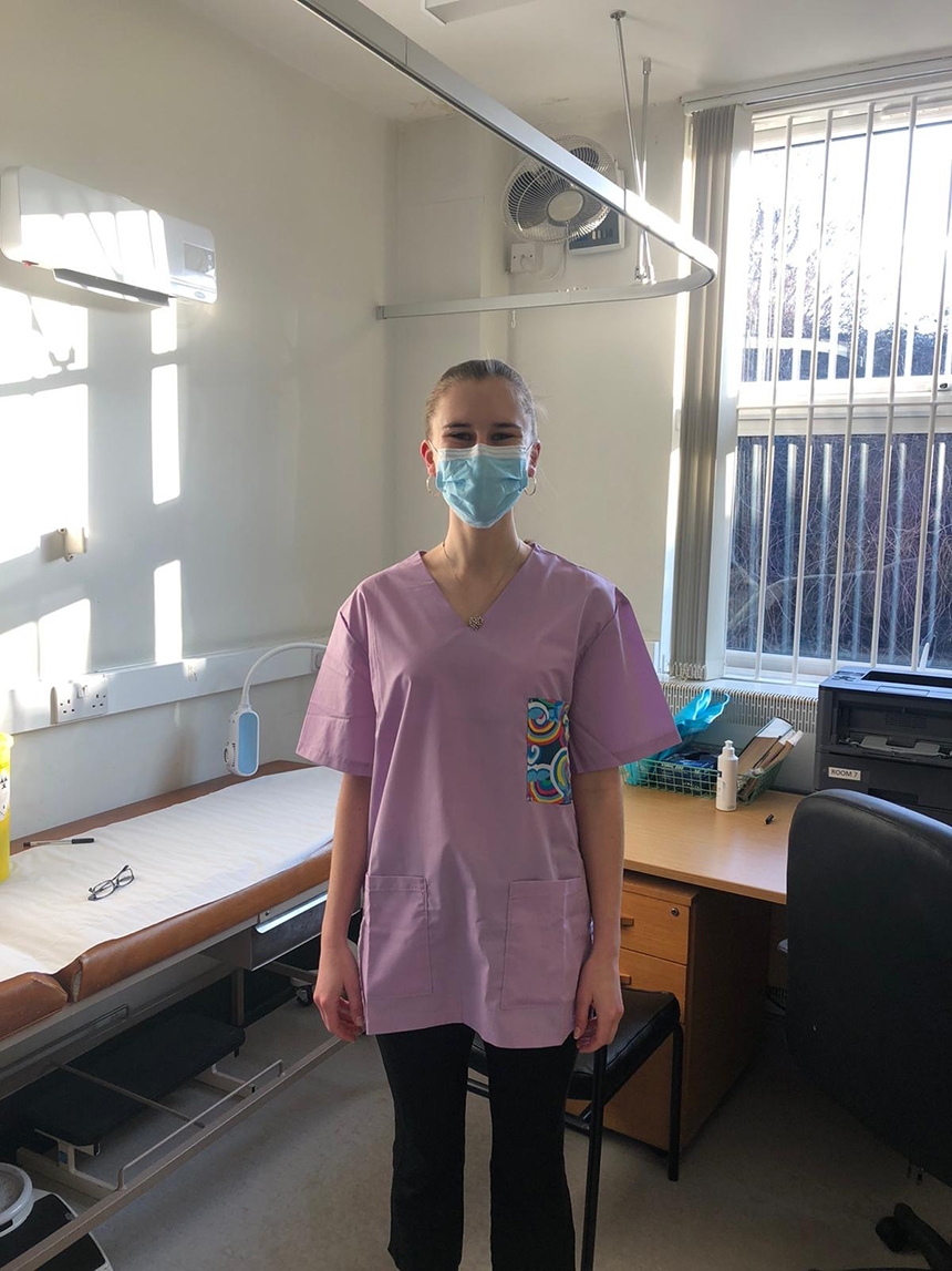 Lexie in her medical scrubs